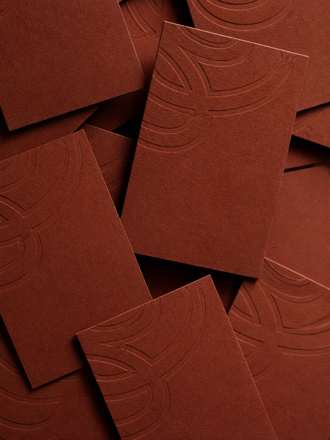 Close-up of red textured paper with embossed flower patterns
